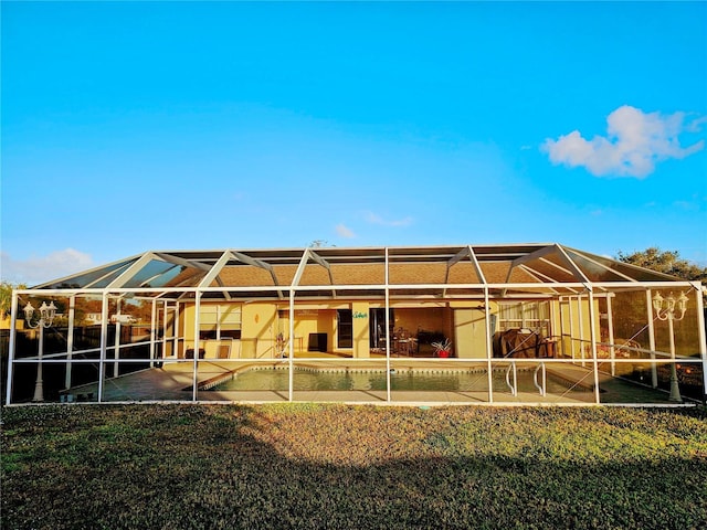 back of house with a lanai and a patio area