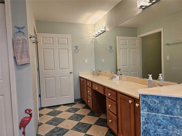 bathroom featuring vanity and a textured ceiling