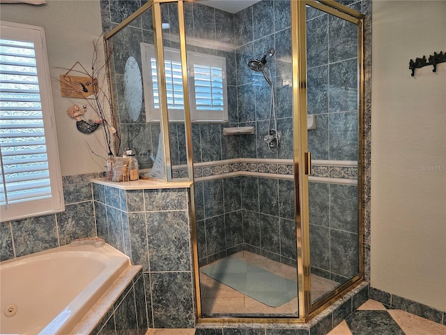 bathroom featuring separate shower and tub