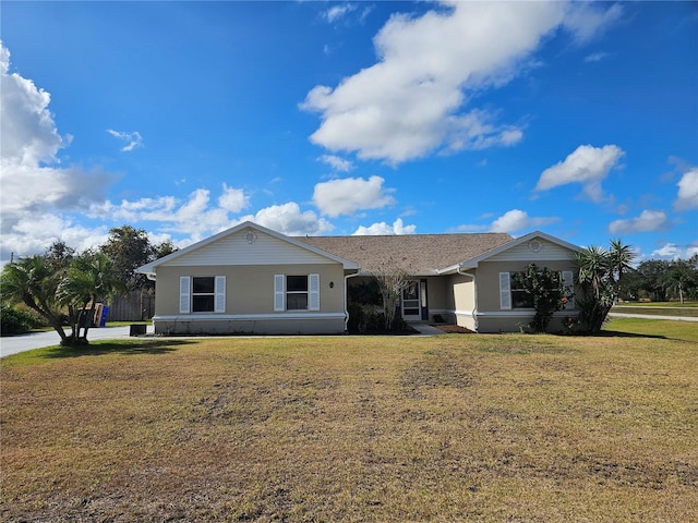 ranch-style home with a front yard