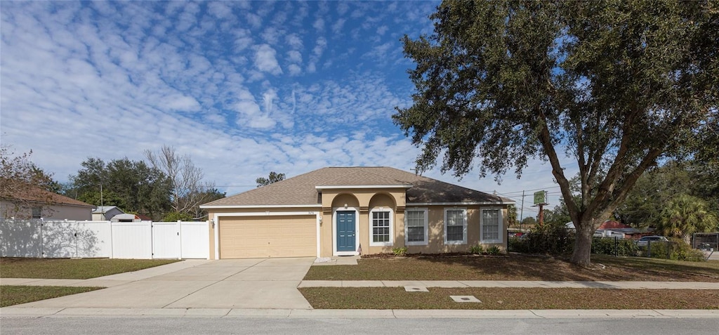 view of front of home featuring a front lawn and a garage