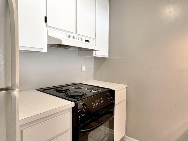 kitchen with white cabinets, white fridge, and black electric range