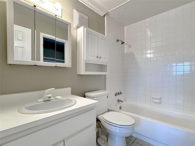 full bathroom with ornamental molding, tile patterned floors, toilet, vanity, and tiled shower / bath