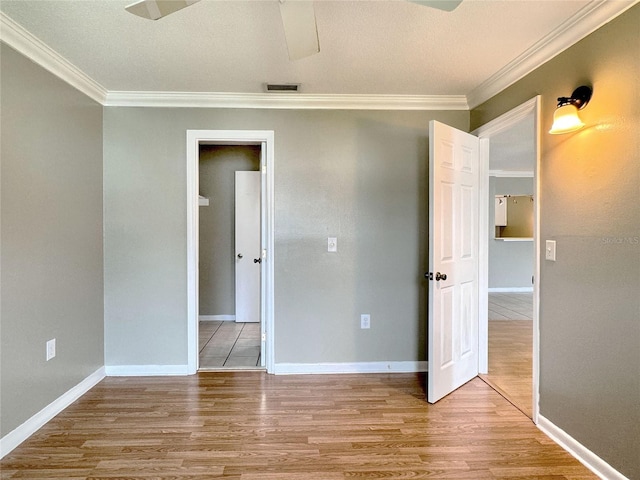 unfurnished bedroom featuring light wood-type flooring and crown molding