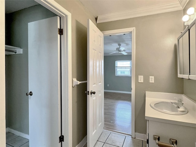 bathroom with vanity, ceiling fan, wood-type flooring, and ornamental molding