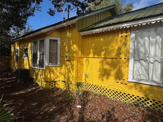 view of side of home featuring central AC