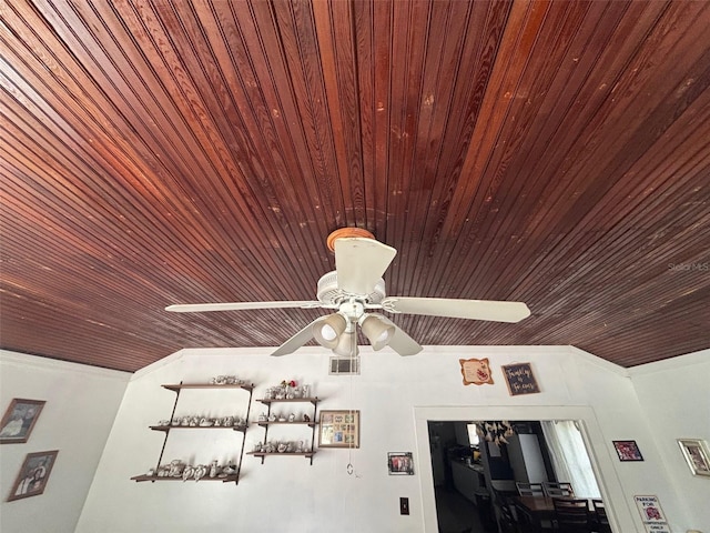 interior details featuring crown molding and wooden ceiling