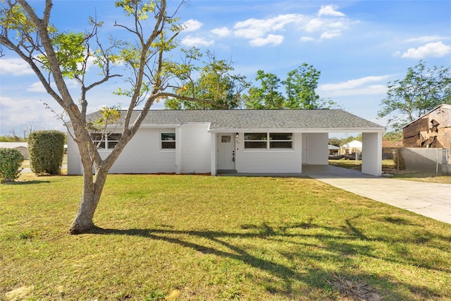 ranch-style home with a front yard and a carport