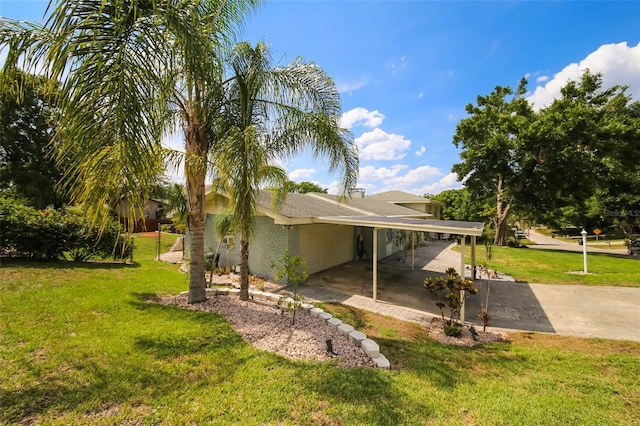 view of property exterior with a carport and a yard