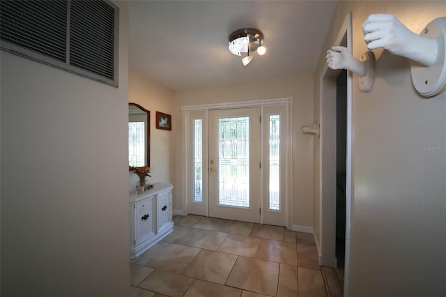 doorway to outside featuring light tile patterned floors