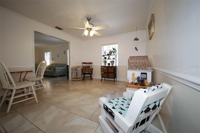 living room featuring a wealth of natural light, ceiling fan, and light tile patterned flooring