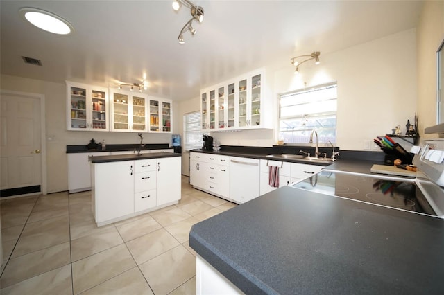 kitchen featuring dishwasher, white cabinets, and a kitchen island