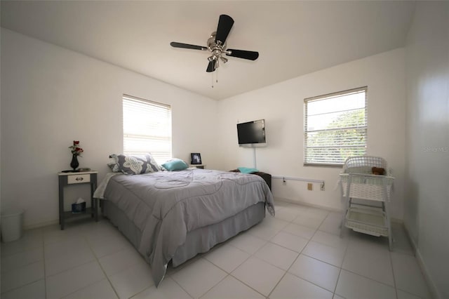 tiled bedroom featuring ceiling fan