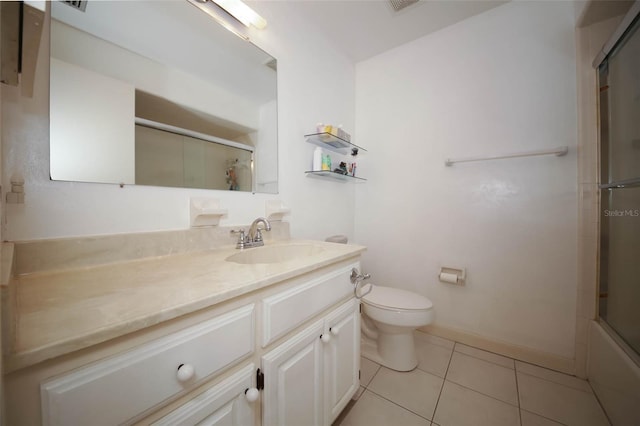 full bathroom with tile patterned flooring, vanity, bath / shower combo with glass door, and toilet