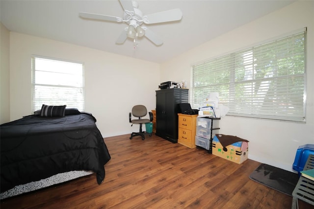 bedroom featuring ceiling fan and dark wood-type flooring