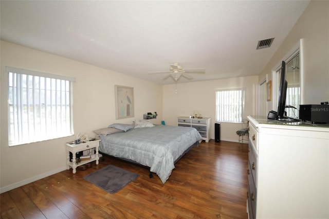 bedroom with ceiling fan and dark hardwood / wood-style floors