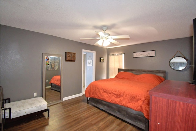 bedroom with ceiling fan, wood-type flooring, and a textured ceiling