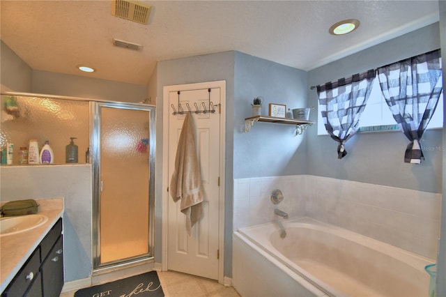 bathroom featuring vanity, a textured ceiling, and independent shower and bath