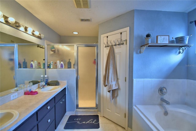 bathroom with tile patterned floors, plus walk in shower, vanity, and a textured ceiling