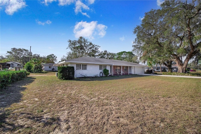 single story home featuring a garage and a front lawn