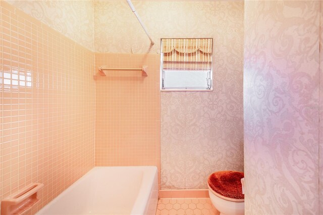 bathroom with tile patterned floors, toilet, and shower / bath combination