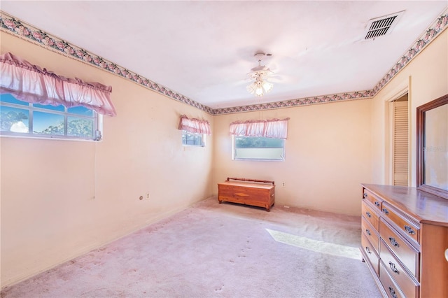 unfurnished bedroom with ceiling fan and light carpet