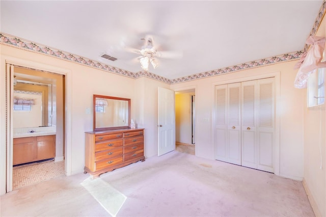 carpeted bedroom with a closet and ceiling fan