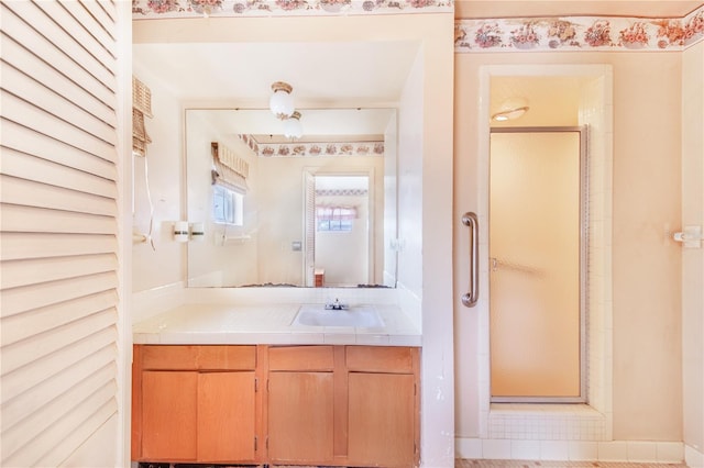 bathroom featuring vanity and a shower with shower door