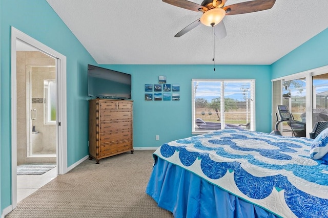 carpeted bedroom featuring lofted ceiling, ensuite bathroom, ceiling fan, and a textured ceiling