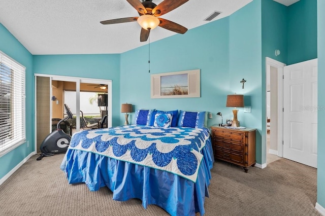 bedroom with multiple windows, carpet, a textured ceiling, and ceiling fan