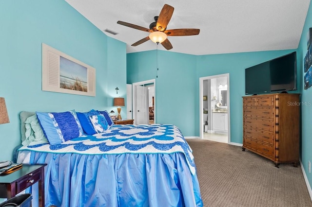 bedroom with carpet flooring, connected bathroom, ceiling fan, a textured ceiling, and vaulted ceiling