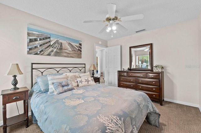 bedroom with a textured ceiling, light colored carpet, and ceiling fan