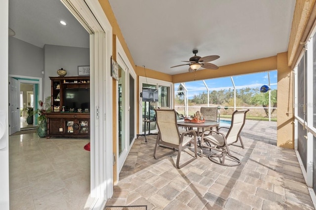 sunroom / solarium with ceiling fan and french doors