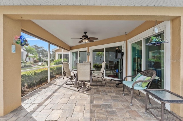 sunroom with ceiling fan