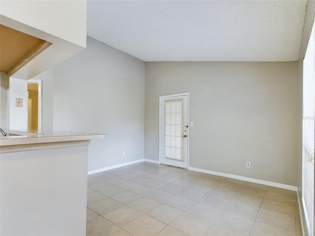 interior space with a textured ceiling and lofted ceiling