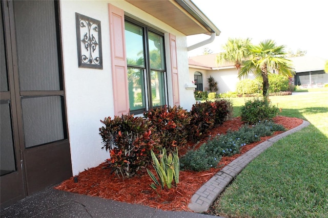 view of side of property with a lawn