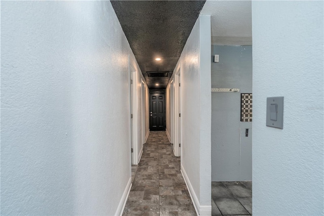 corridor featuring a textured ceiling