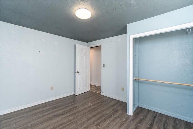 unfurnished bedroom with dark hardwood / wood-style flooring and a textured ceiling