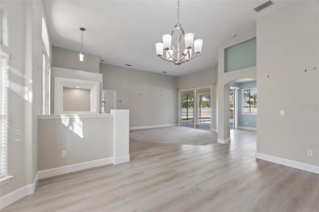 interior space with light hardwood / wood-style flooring and a notable chandelier