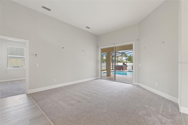 unfurnished room featuring light carpet