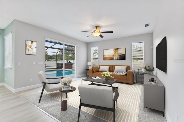 living room featuring ceiling fan and light wood-type flooring