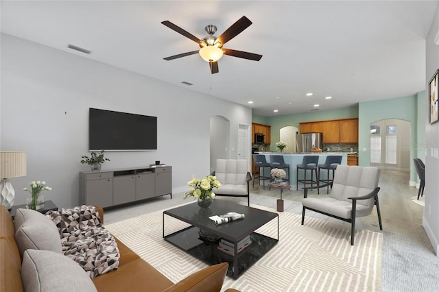 living room featuring ceiling fan and light colored carpet