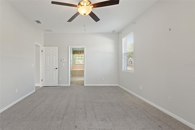 carpeted spare room featuring ceiling fan