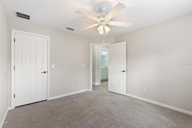 unfurnished room featuring light colored carpet and ceiling fan