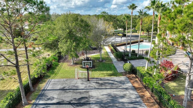 view of home's community featuring basketball hoop