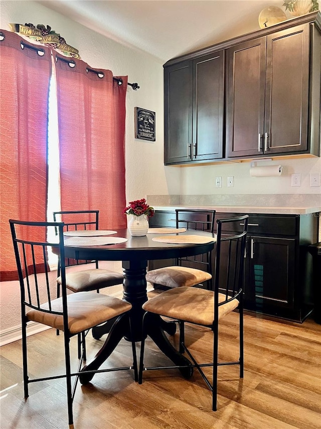 dining space with light hardwood / wood-style flooring