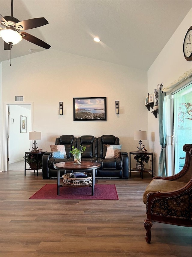 living room with ceiling fan, dark hardwood / wood-style flooring, and vaulted ceiling