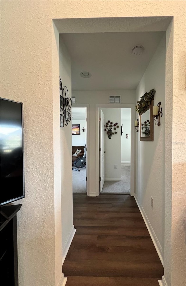 corridor featuring dark wood-type flooring