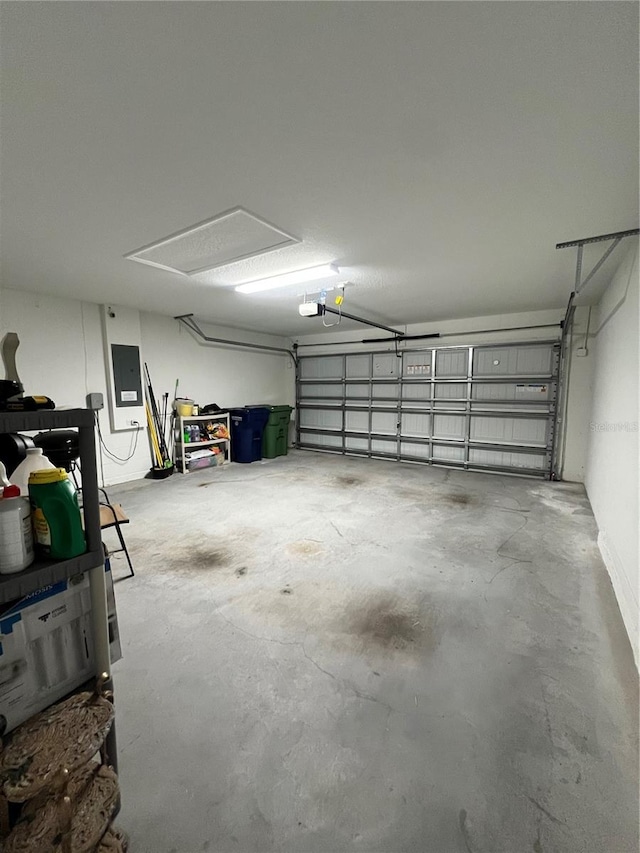 garage with a garage door opener and electric panel