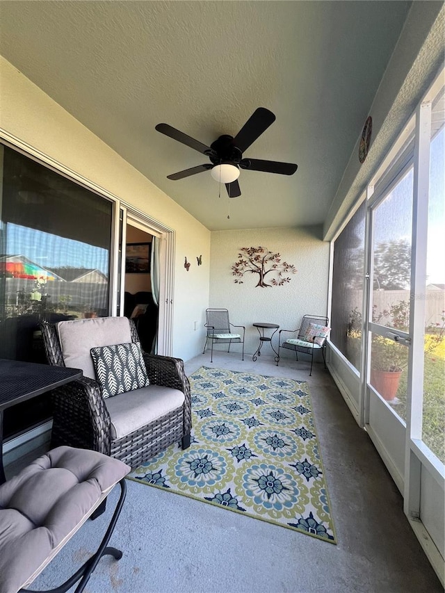 sunroom / solarium featuring ceiling fan